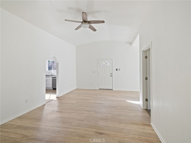 spare room with vaulted ceiling, ceiling fan, and light hardwood / wood-style floors