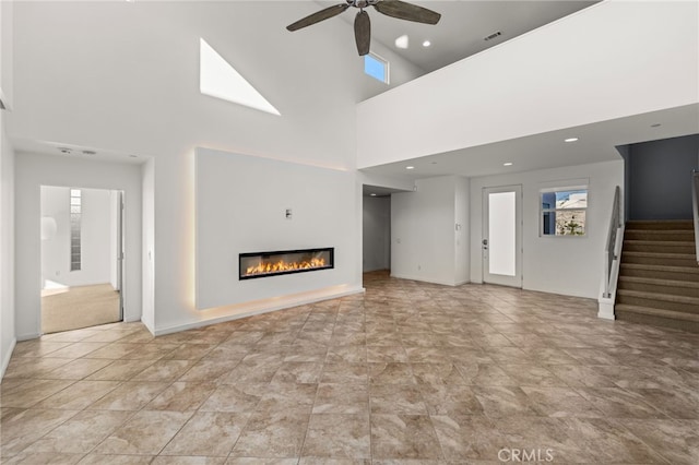 unfurnished living room with ceiling fan