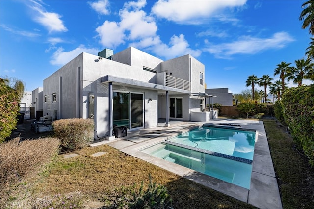 back of house with a balcony and a patio area