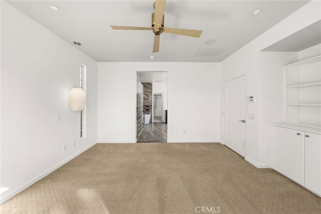 unfurnished room with carpet and ceiling fan