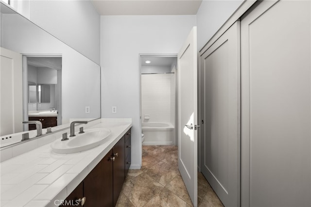 full bathroom featuring vanity, toilet, and  shower combination