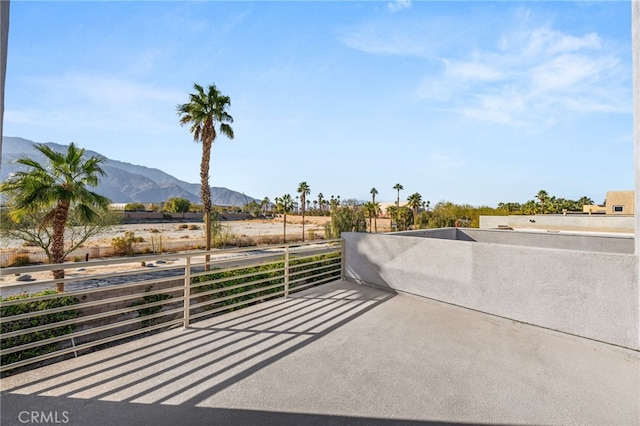 view of patio / terrace with a balcony and a mountain view