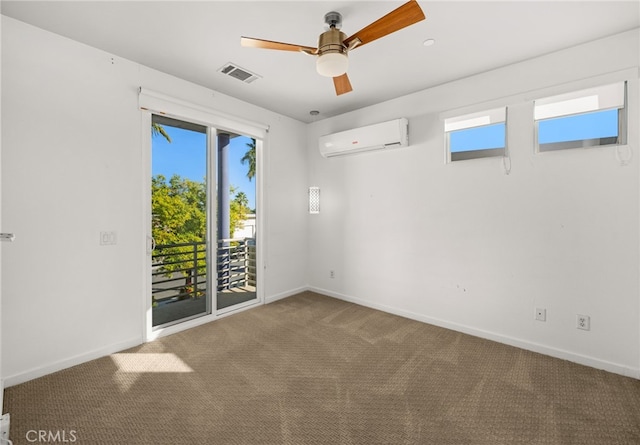 carpeted spare room featuring a wealth of natural light, a wall mounted air conditioner, and ceiling fan