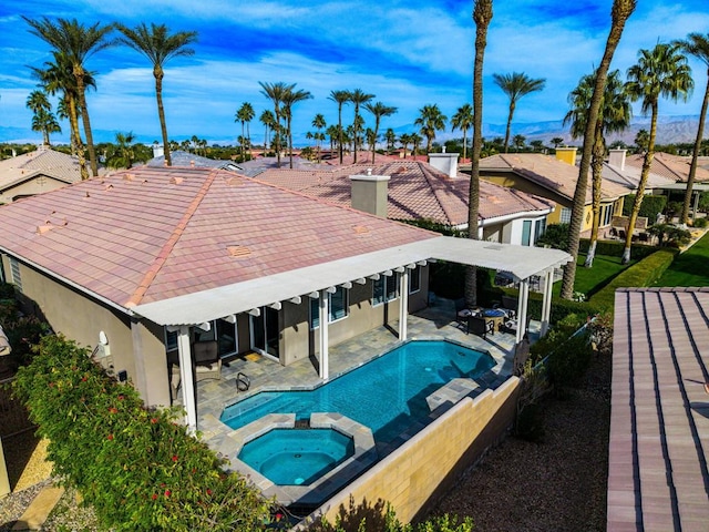 view of swimming pool with an in ground hot tub and a patio