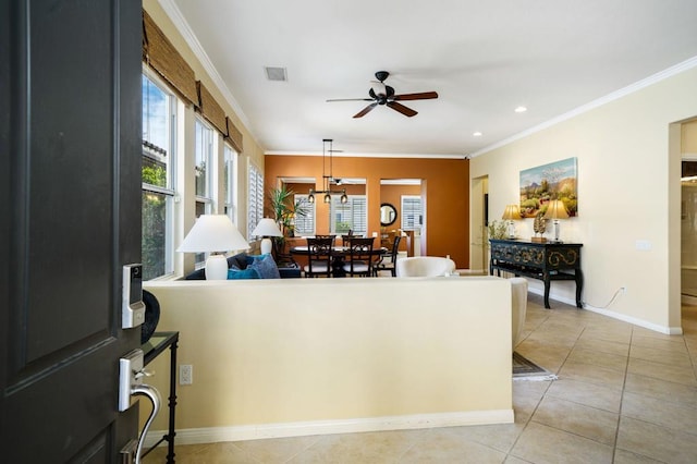 living room with crown molding, light tile patterned floors, and ceiling fan