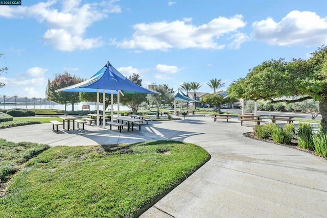 view of community featuring a lawn and a water view