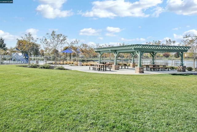 surrounding community featuring a pergola and a lawn