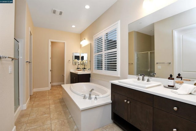 bathroom featuring tile patterned floors, vanity, and plus walk in shower