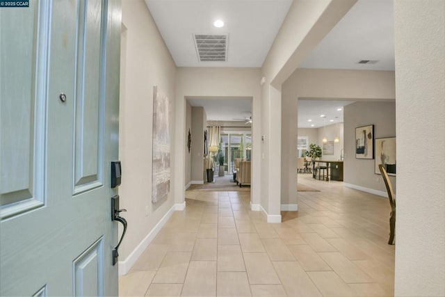 entryway with ceiling fan and light tile patterned floors