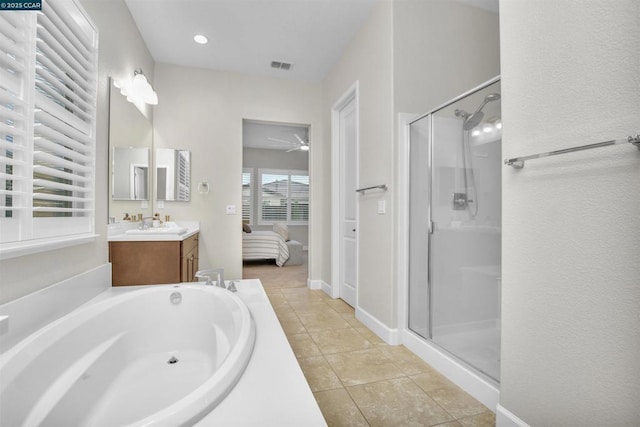 bathroom with independent shower and bath, vanity, and tile patterned flooring