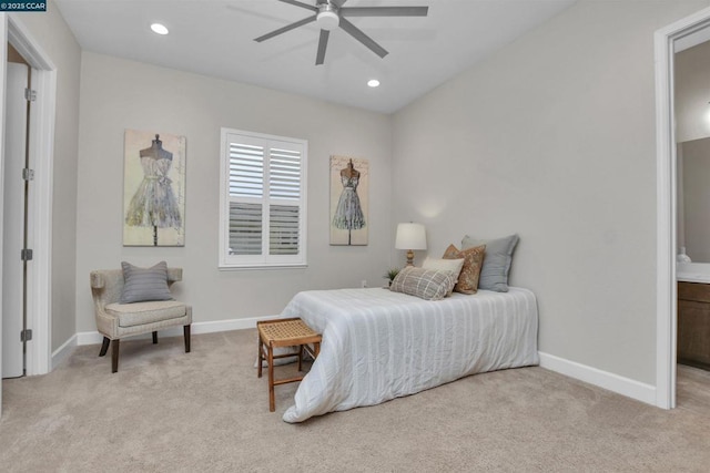 bedroom with ensuite bath, light colored carpet, and ceiling fan