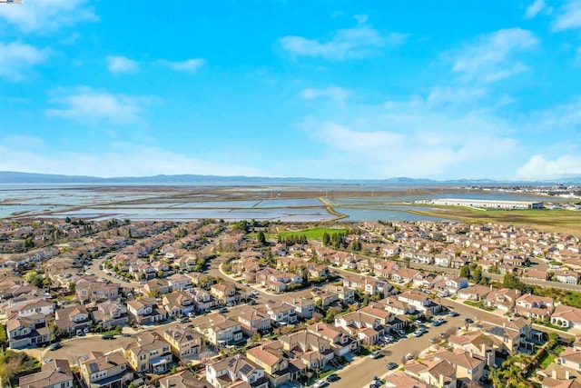 birds eye view of property featuring a water and mountain view