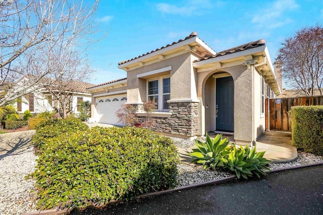 mediterranean / spanish-style house with a garage