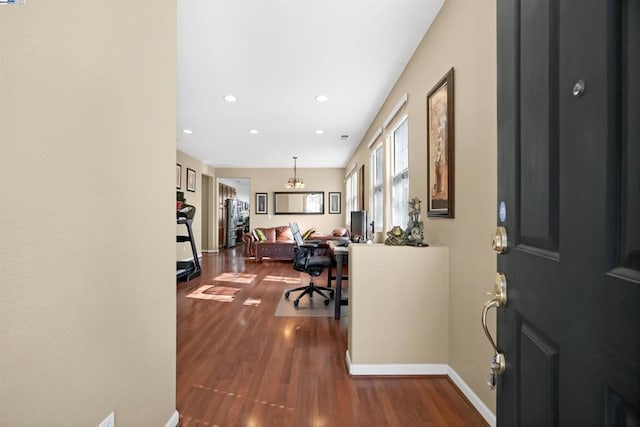 home office featuring hardwood / wood-style floors and a chandelier