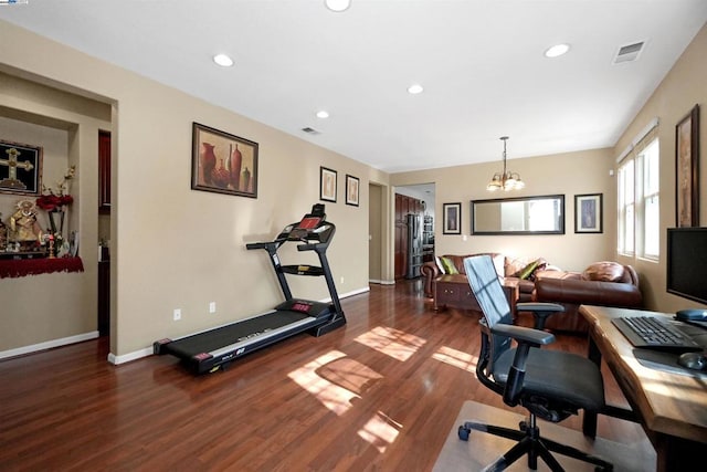 office with dark wood-type flooring and a notable chandelier