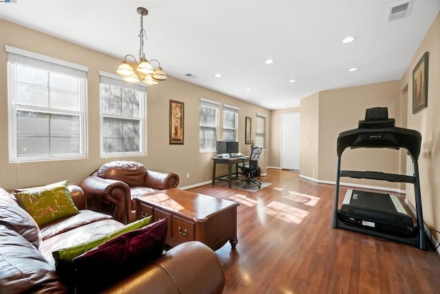 living room featuring wood-type flooring and a chandelier