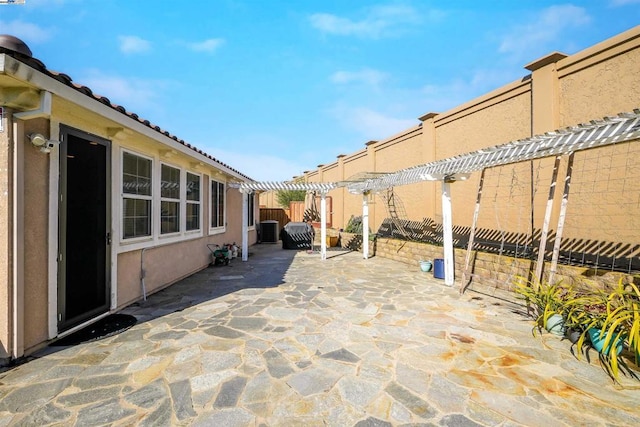 view of patio featuring cooling unit and a pergola