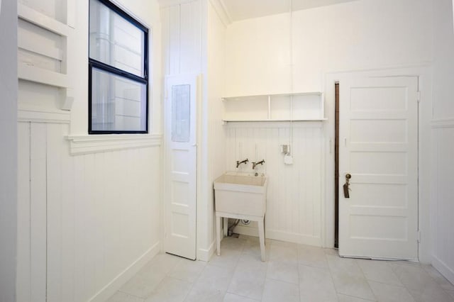 laundry room with hookup for a washing machine and light tile patterned floors