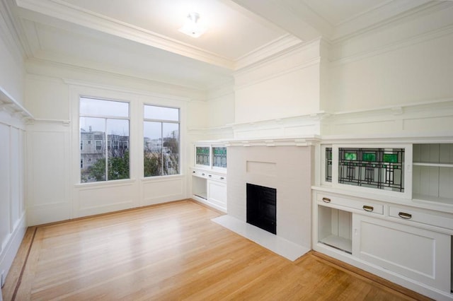 unfurnished living room featuring crown molding and light hardwood / wood-style floors