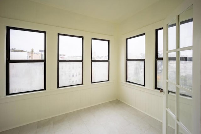 unfurnished sunroom featuring plenty of natural light