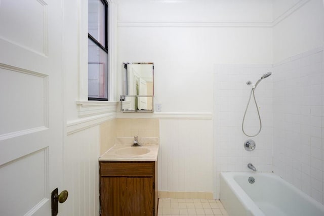 bathroom with tiled shower / bath, vanity, and tile patterned flooring