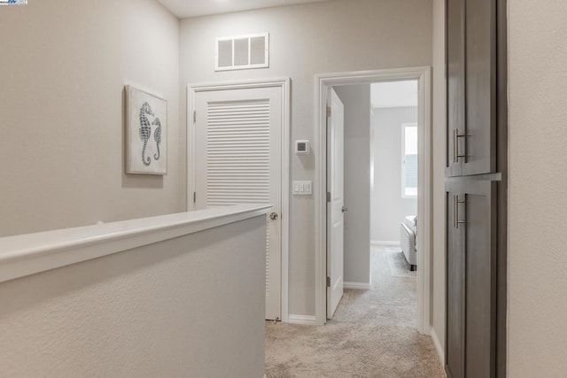 hallway with light carpet