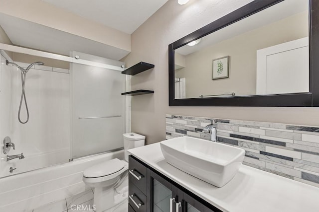 full bathroom with toilet, vanity, bath / shower combo with glass door, and backsplash