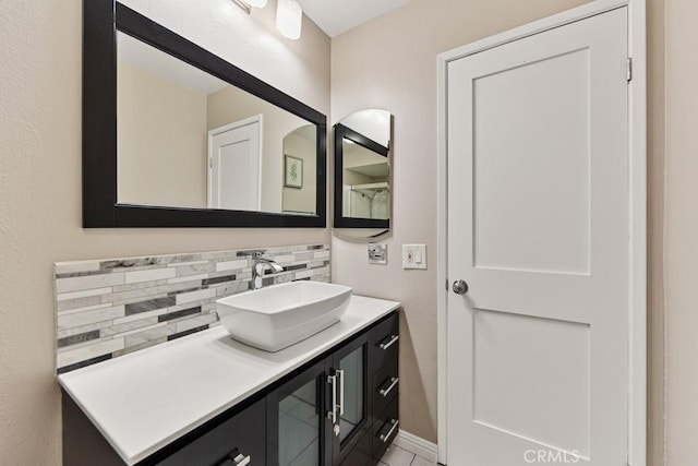 bathroom with tasteful backsplash and vanity