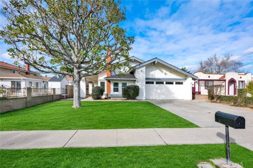 view of front of home with a garage and a front yard