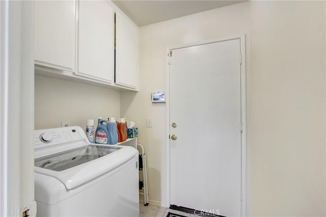 washroom with washer / dryer and cabinets