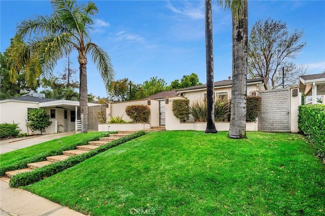 view of front of house with a carport and a front yard