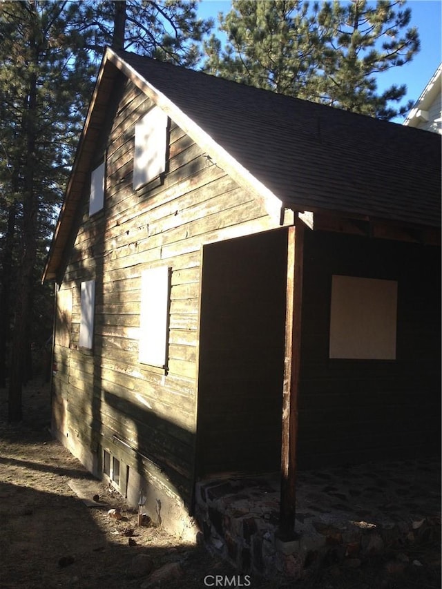 view of side of property with an outbuilding