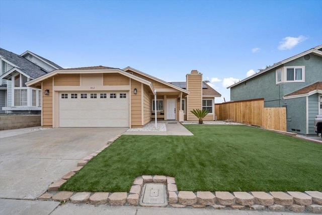 view of front of property with a garage and a front lawn