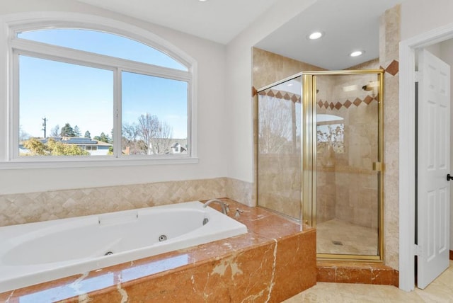 bathroom featuring shower with separate bathtub