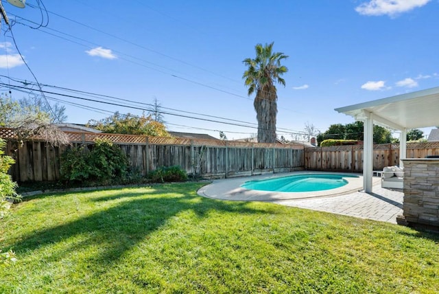 view of swimming pool featuring a patio and a yard