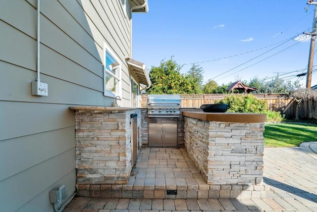 view of patio / terrace with area for grilling and a grill