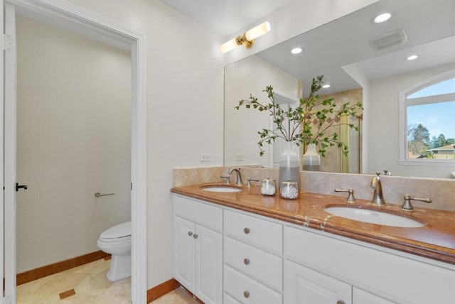 bathroom featuring vanity and toilet