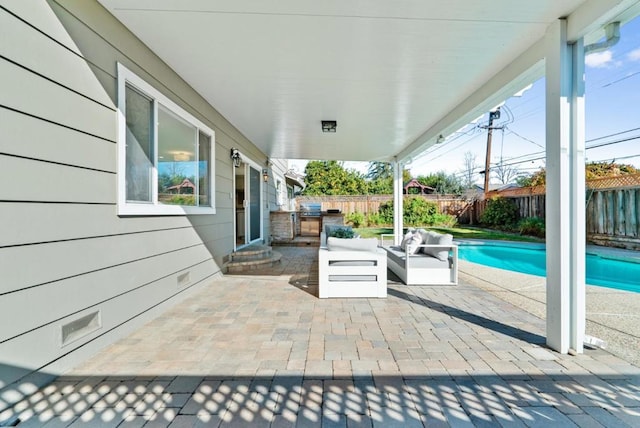 view of patio featuring area for grilling, a fenced in pool, and an outdoor hangout area