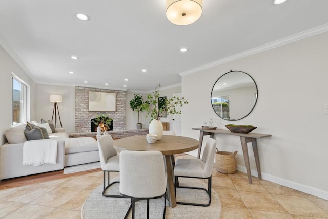 tiled dining area with crown molding and a fireplace