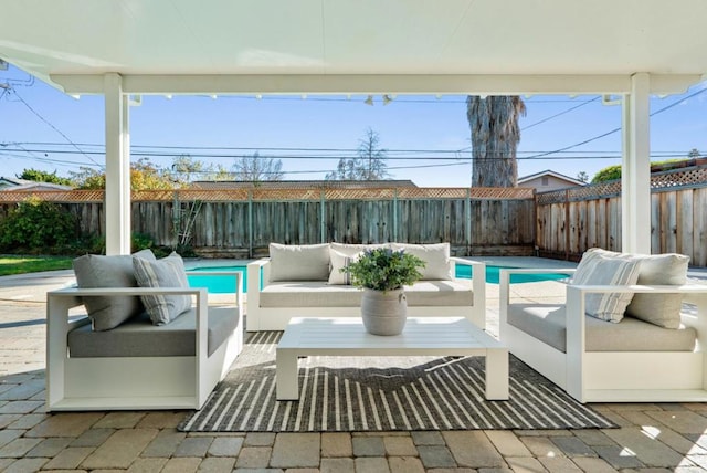 view of patio featuring an outdoor living space and a fenced in pool