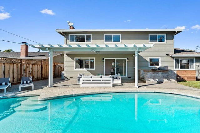 rear view of property featuring a fenced in pool, a patio, an outdoor kitchen, and an outdoor bar