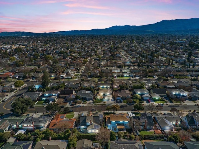 aerial view at dusk featuring a mountain view