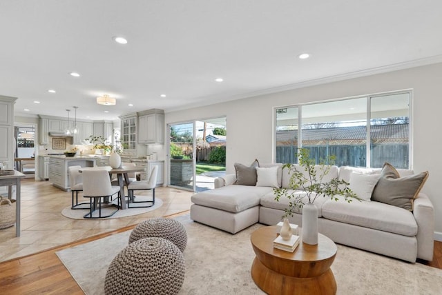 living room featuring crown molding and light hardwood / wood-style floors