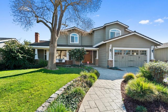 craftsman inspired home featuring a garage and a front yard