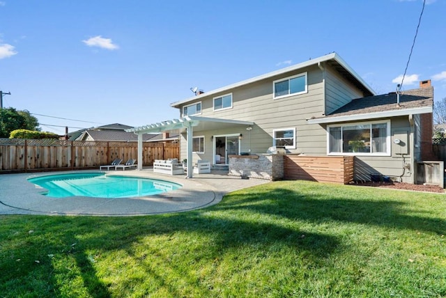 rear view of property featuring a fenced in pool, a patio, a yard, and a pergola