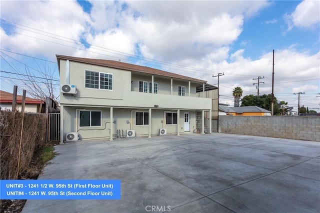 rear view of property with ac unit