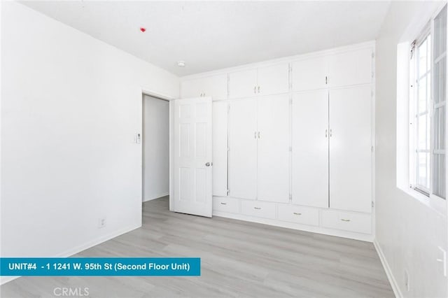 unfurnished bedroom with light wood-type flooring