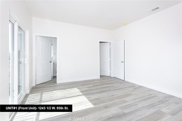 unfurnished bedroom featuring light wood-type flooring