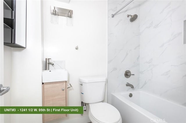 full bathroom featuring vanity, tiled shower / bath combo, and toilet