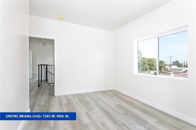 empty room with light hardwood / wood-style flooring